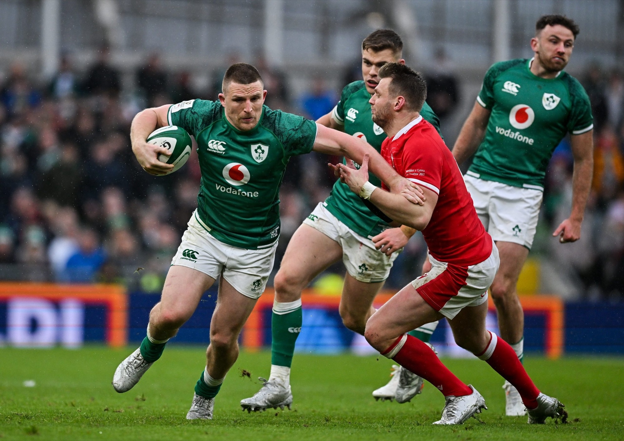Andrew Conway carrying the ball through a tackle for Ireland.