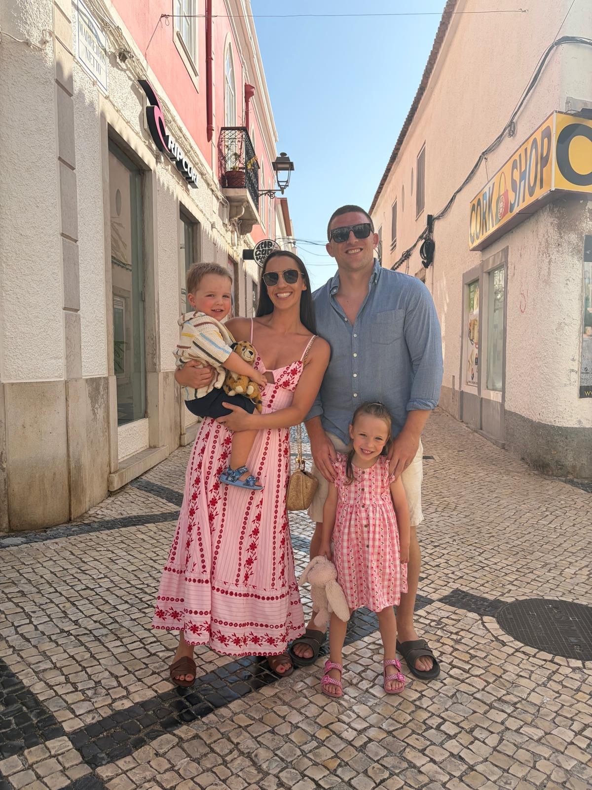 Andrew Conway with his family on a sunlit street.
